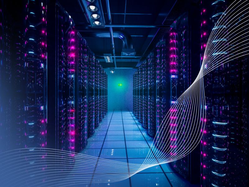 Modern data centre server room illuminated with blue and purple lights, representing the high-availability environments supported by MEMS data centre power solutions